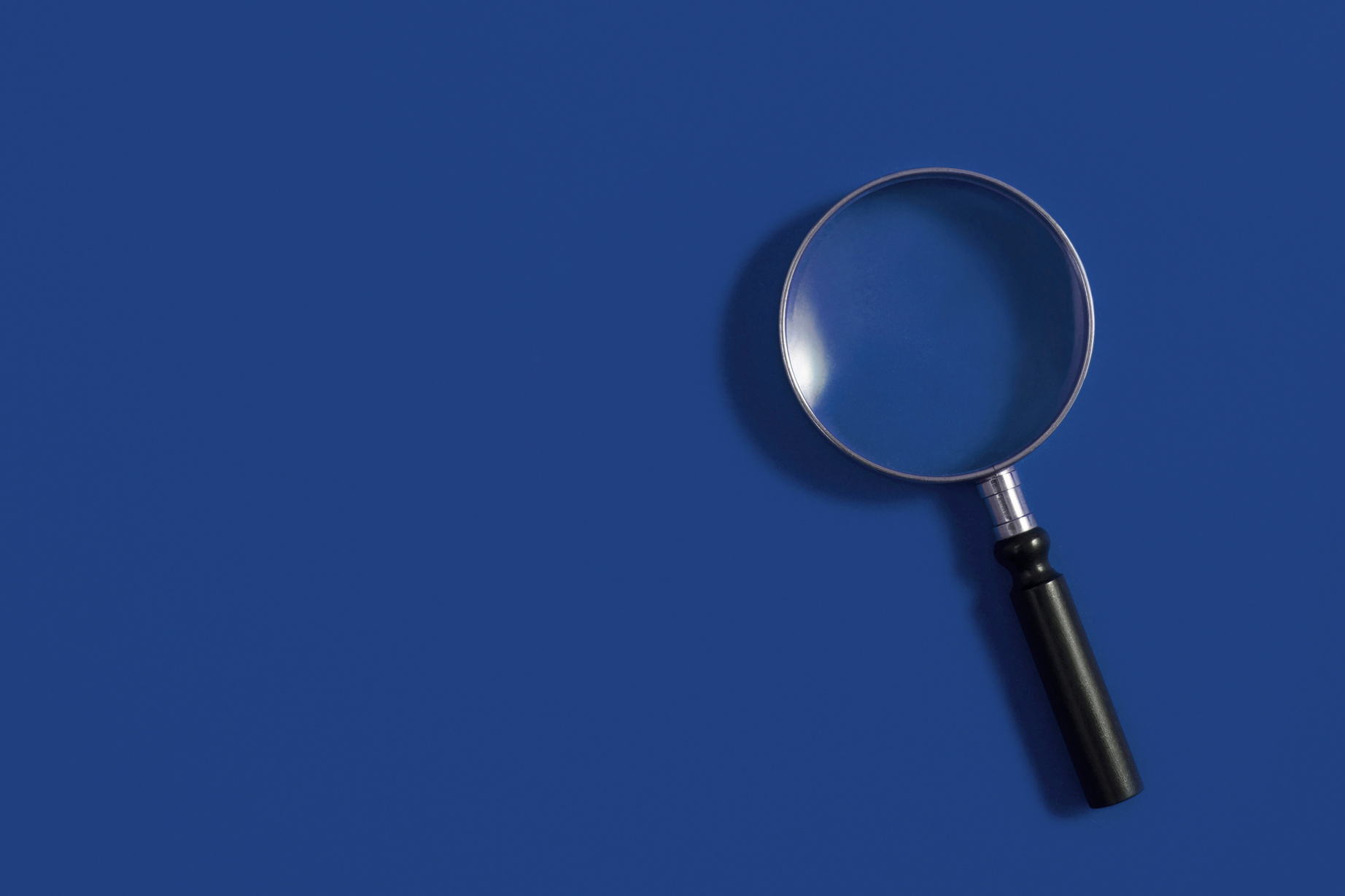 Magnifying Glass on Classic Blue Background